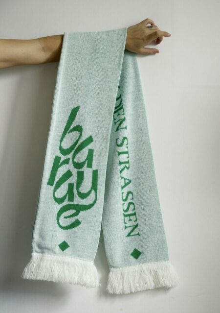 Charity scarf white green hangs on the arm